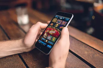 A cheerful woman in traditional clothing using her smartphone during a festive moment, showing how easily the JL777 app fits into everyday life.